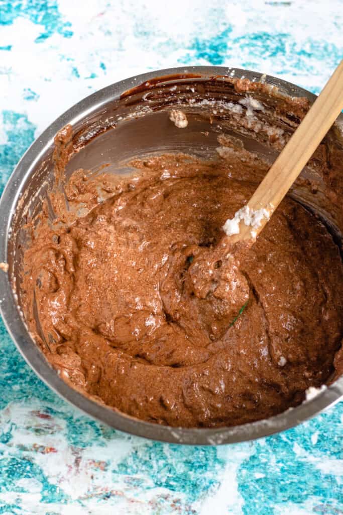 Fully combined batter in a mixing bowl with rubber spatula