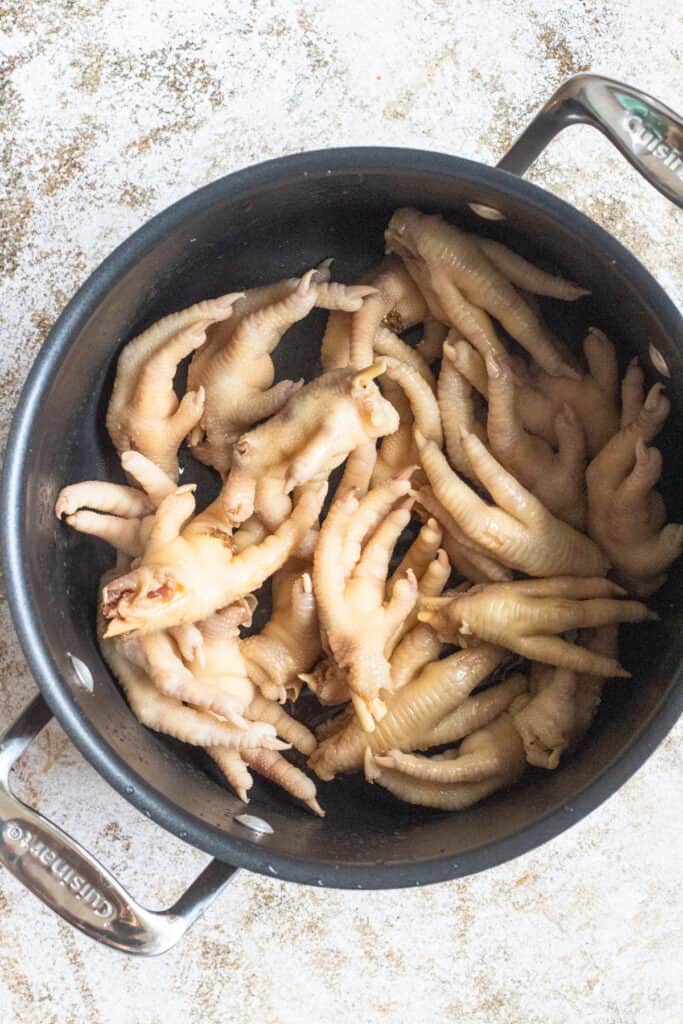 chicken feet with toenails in a large pot 