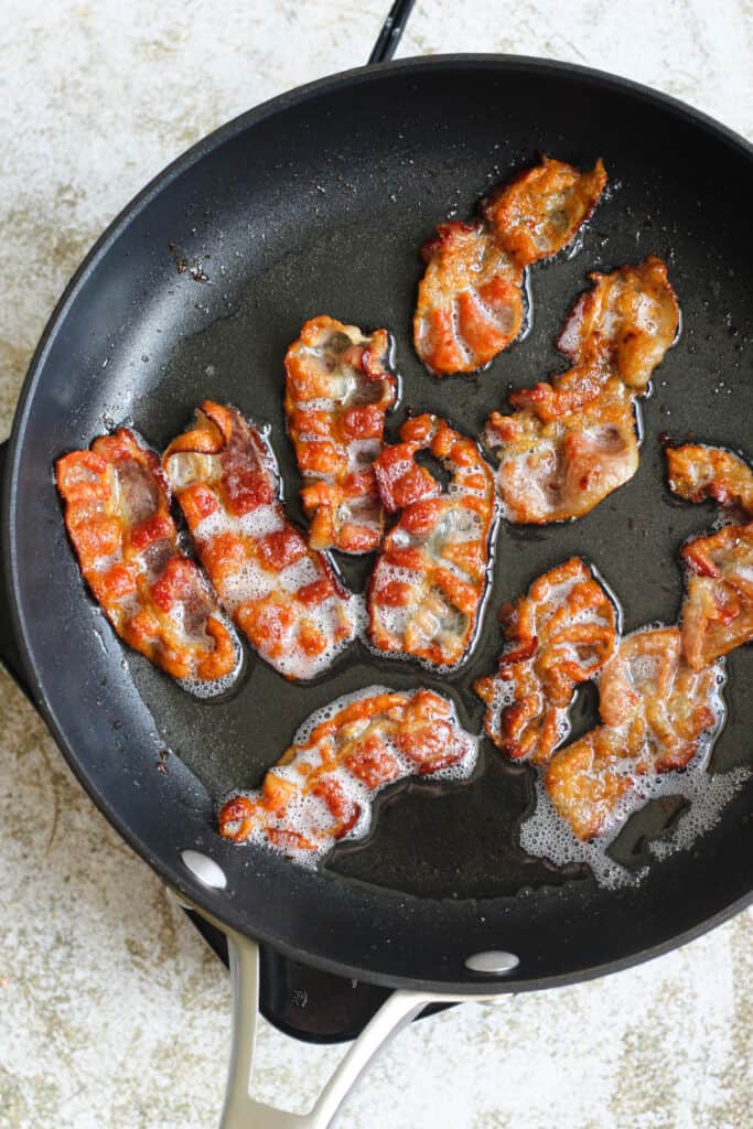 cooked bacon in a frying pan 