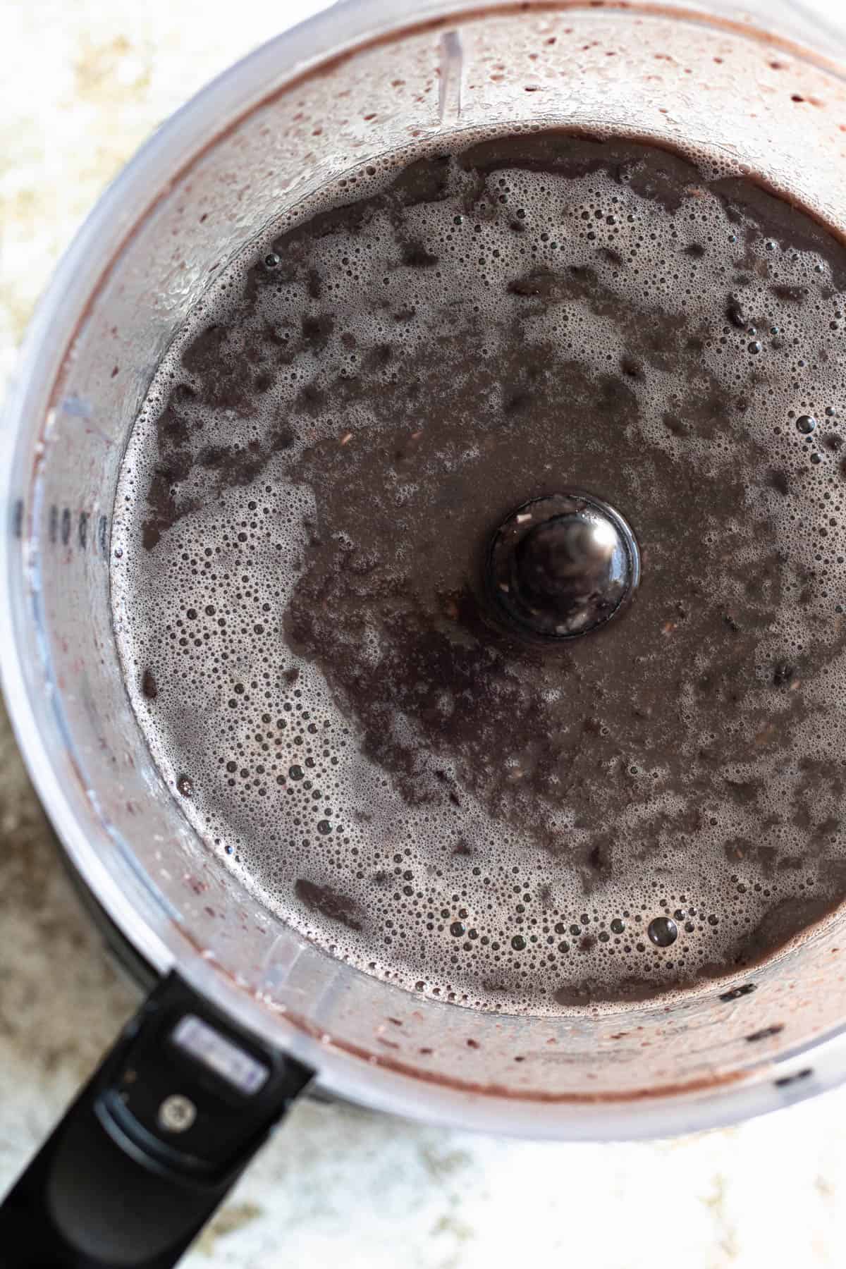 Black beans and water in a blender