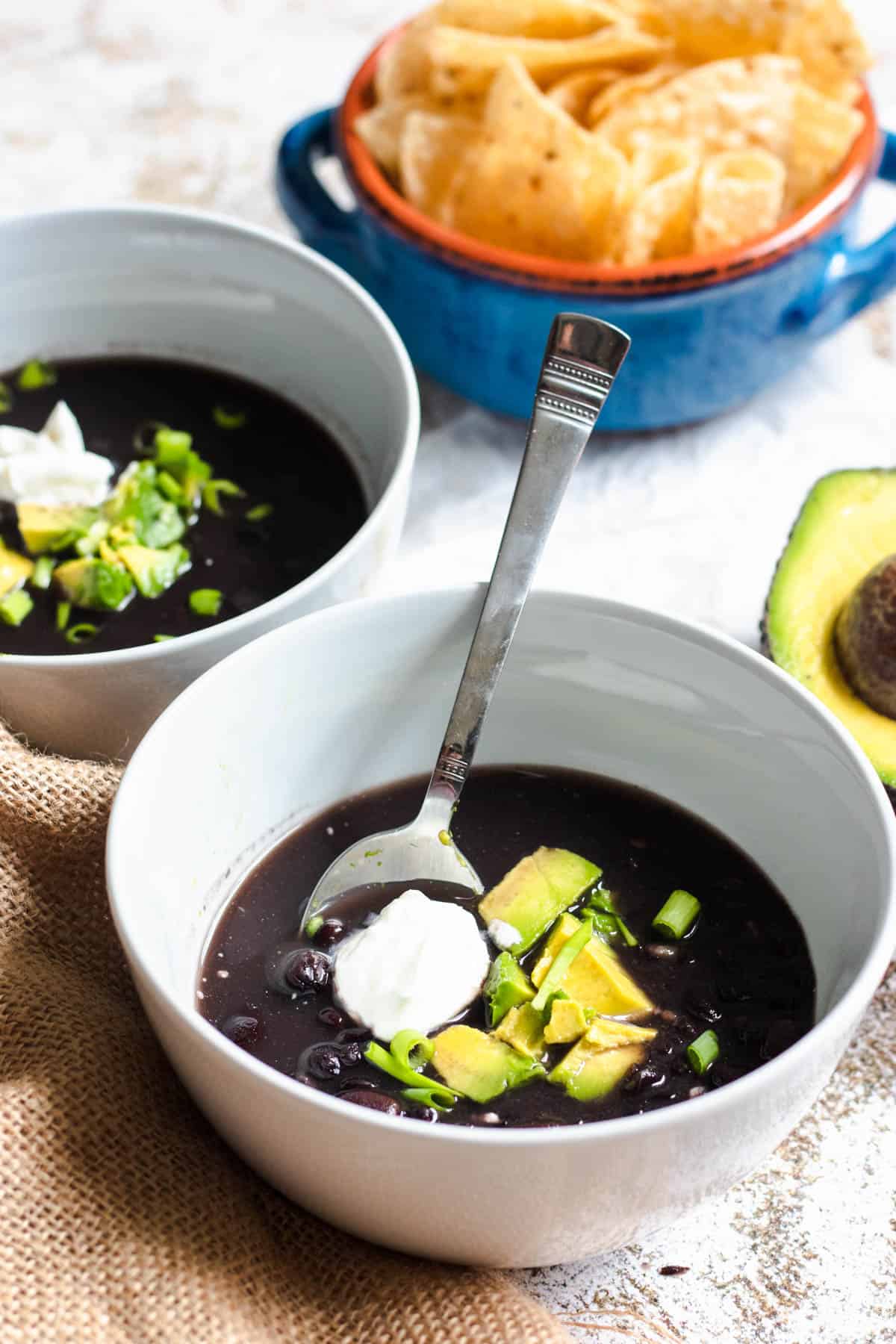 Instant Pot Black Bean Soup with tortilla chips and guacamole