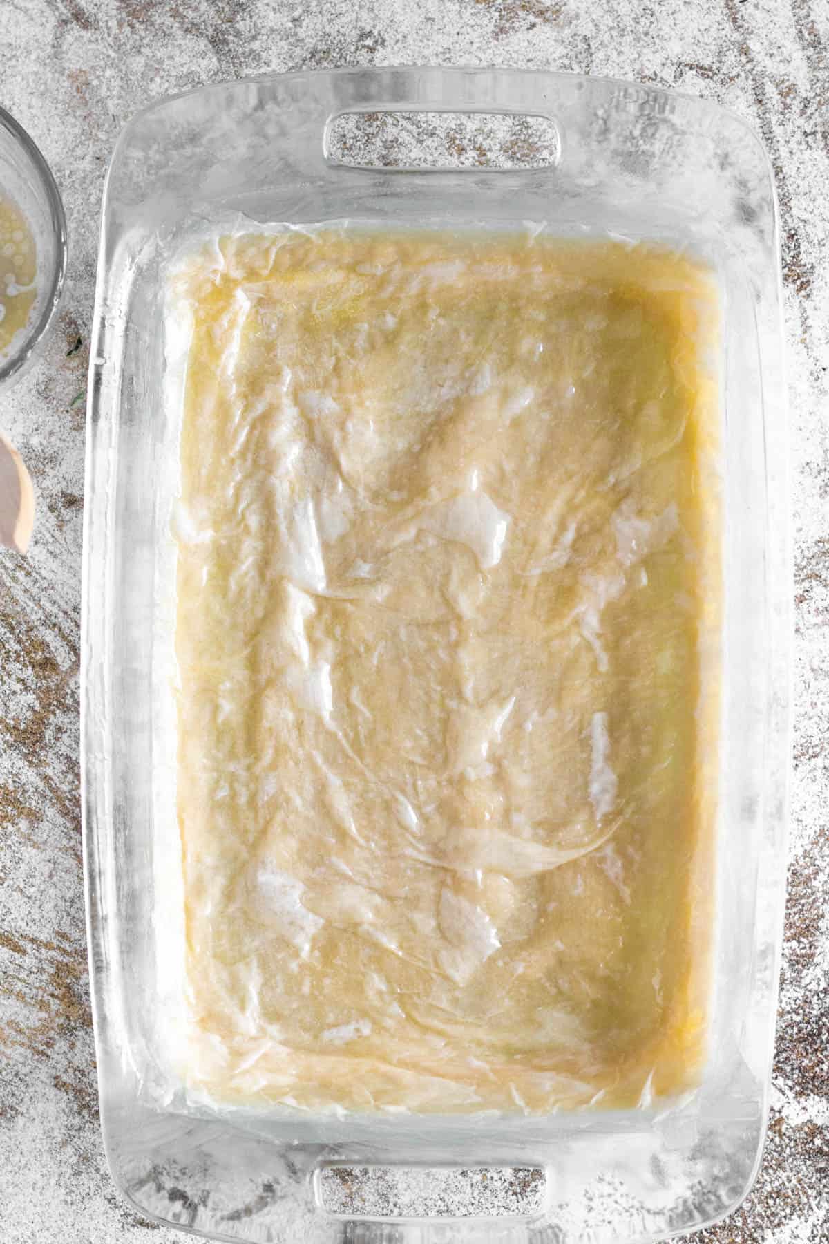 9x13 pan with layers of phyllo dough in the bottom 