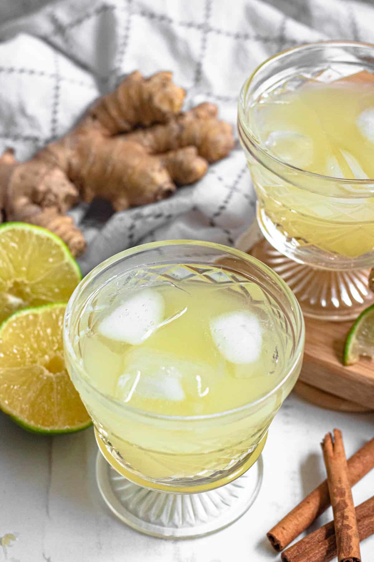 Overhead view of ginger juice with limes and ice 