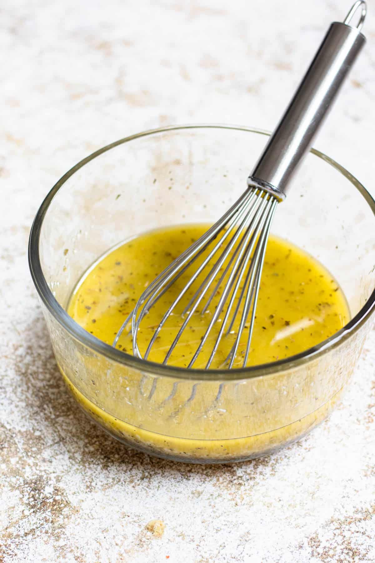 Bowl of dressing with a whisk