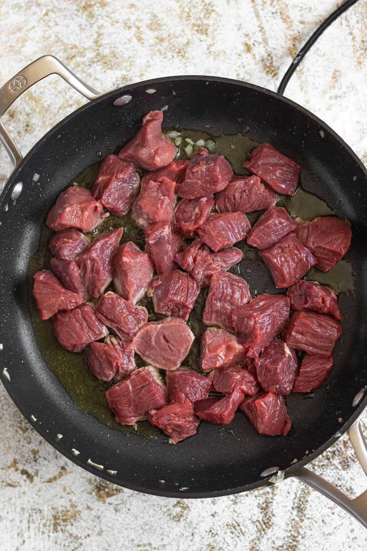Raw lamb in a pan with ghee