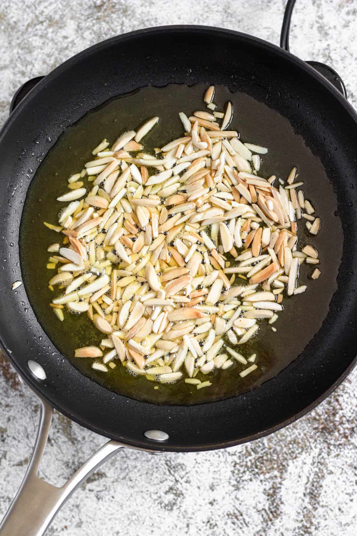Almonds toasting in a pan with ghee