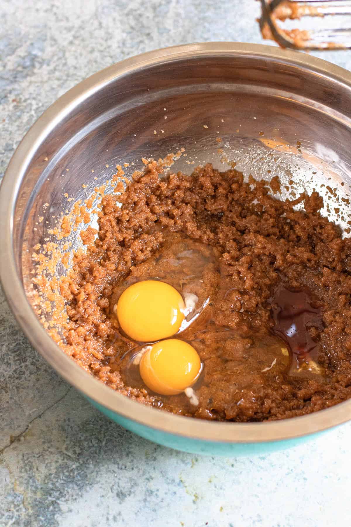 Eggs added to a mixing bowl to make brownies.