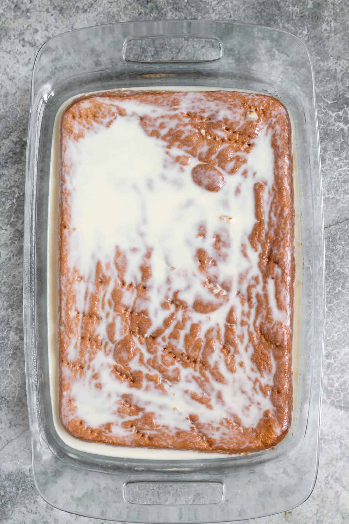 Cake with tres leches mixture poured over it