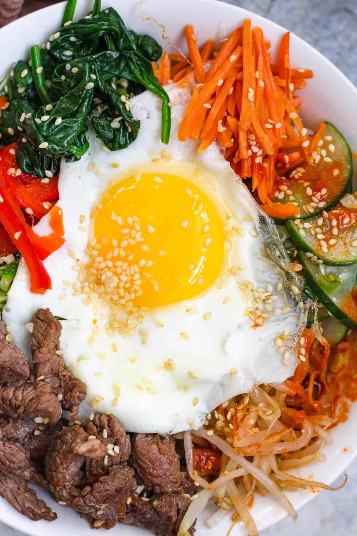 Close up of beef bibimbap with a sunny side up egg