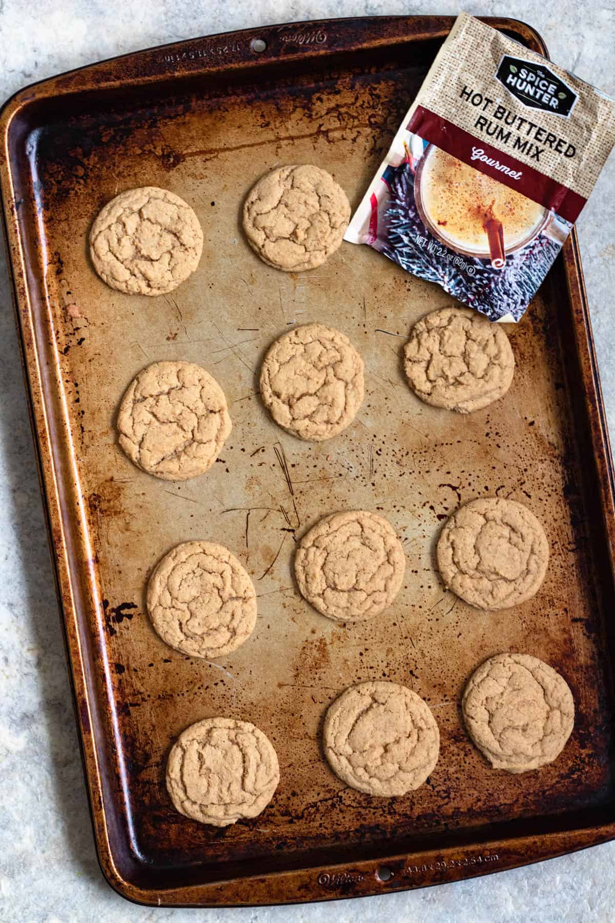Baked cookies on a cookie sheet with hot buttered rum cookies