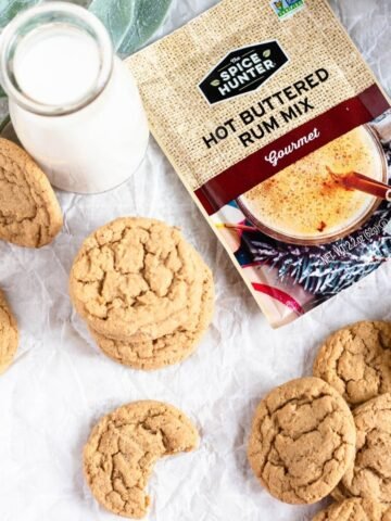 Hot Buttered Rum Cookies on parchment paper with a seasoning packet next to them.