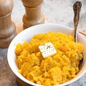 Rutabaga Mash sprinkled with black pepper and topped with butter.