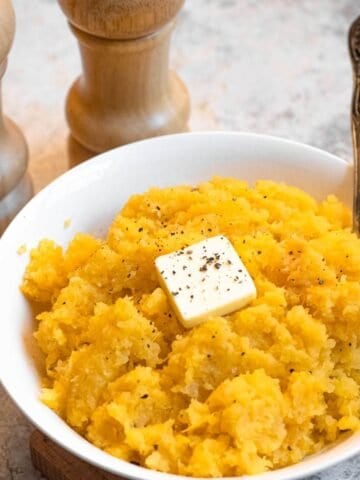 Rutabaga Mash sprinkled with black pepper and topped with butter.