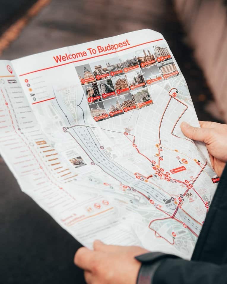 Hands holding a map that says "welcome to Budapest" in the Hungary country introduction. 