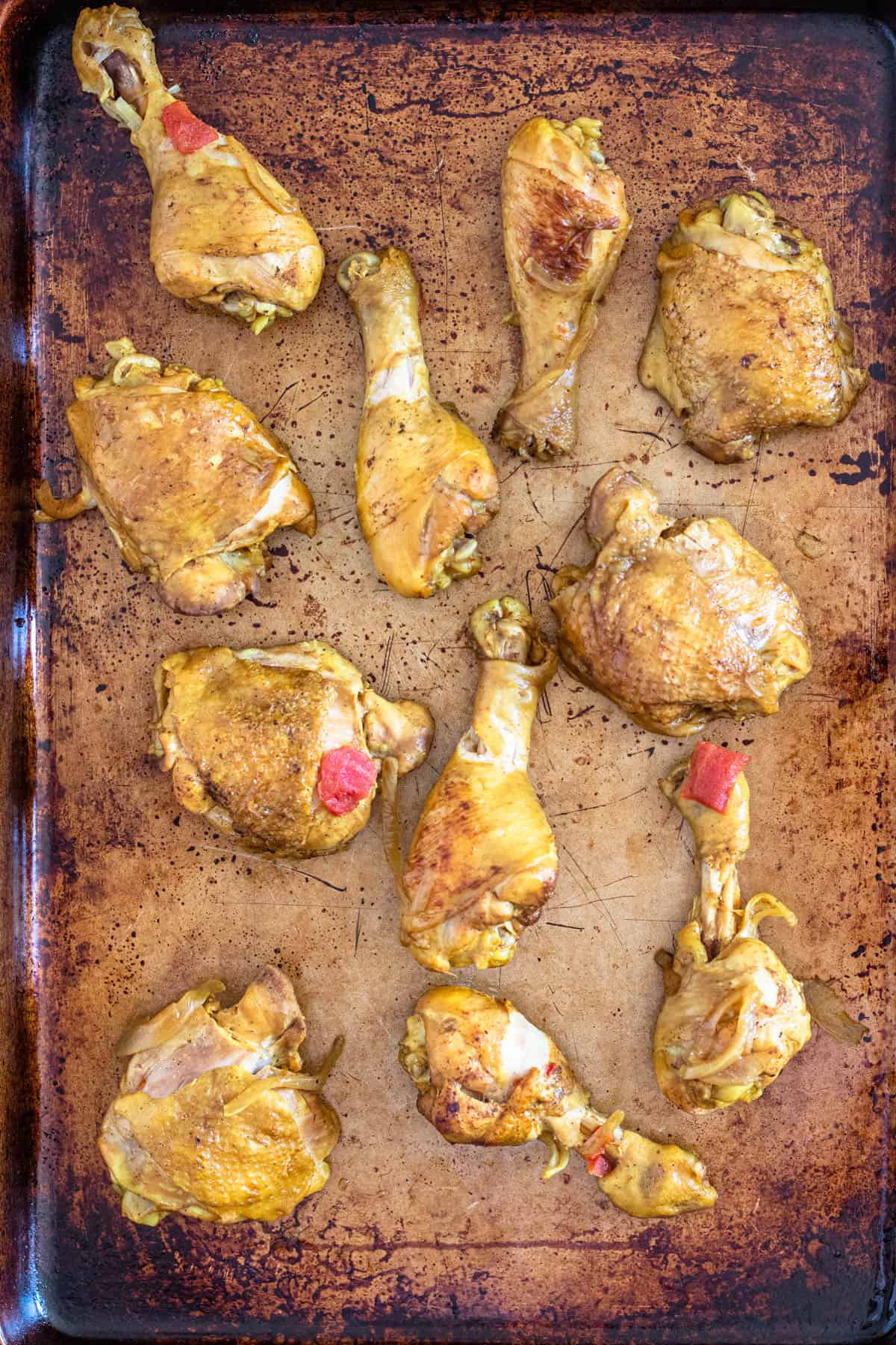 Boiled chicken on a sheet pan ready to broil. 