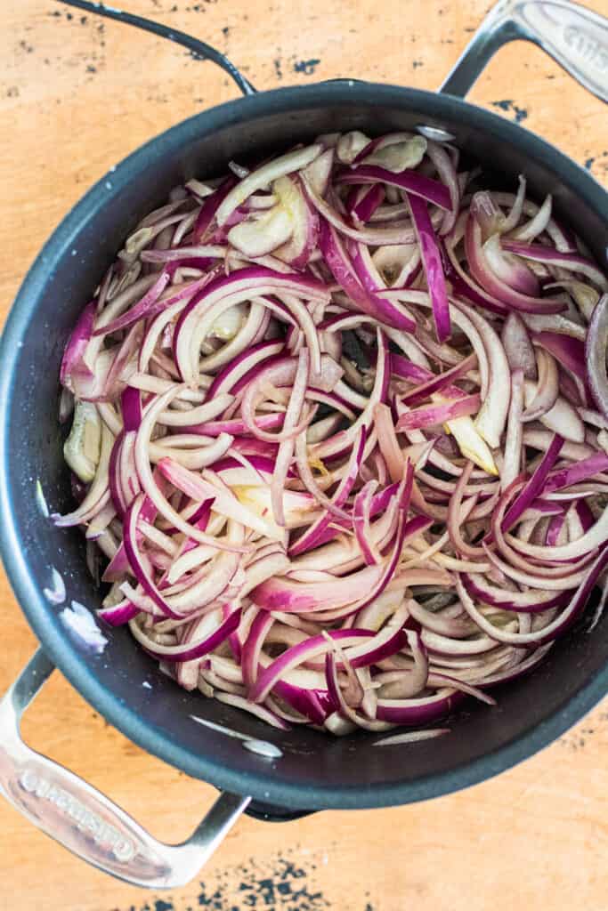 Sliced red onions in a pan.