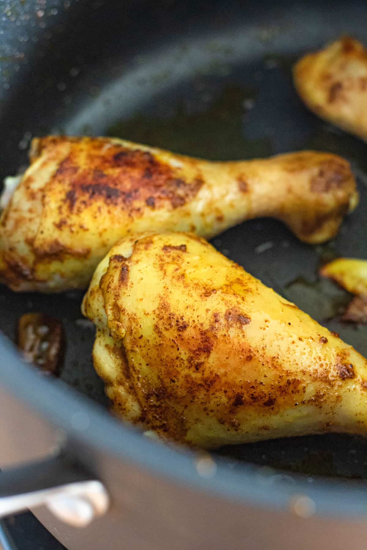 Chicken pieces in a saucepan. 