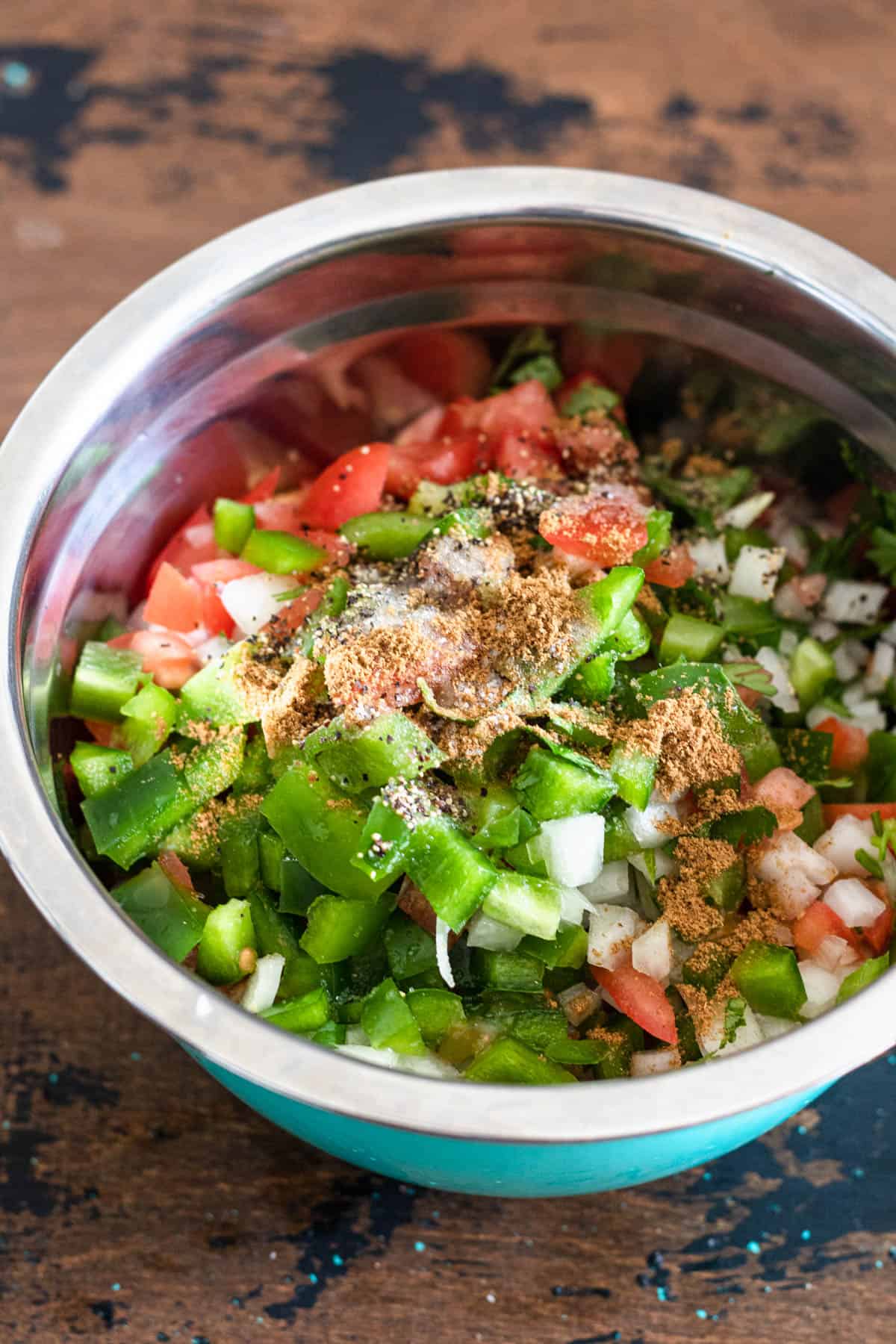 A bowl of vegetables waiting to get mixed into a chismol.