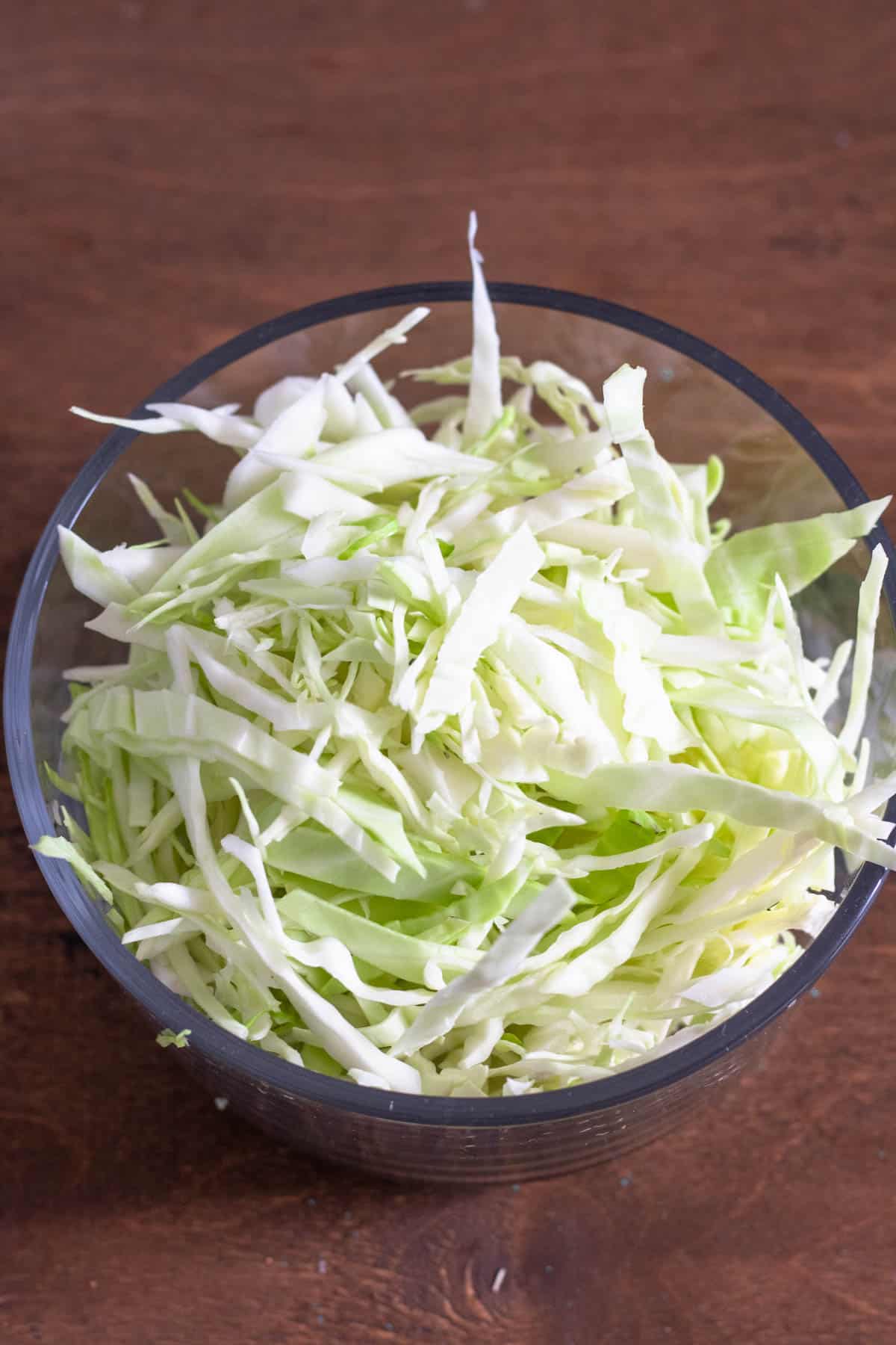 Glass bowl of shredded cabbage. 