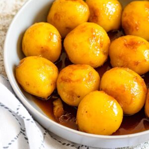 Caramelized Potatoes in a large bowl with small, golden potatoes coated in caramel sauce.
