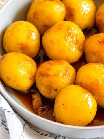 Caramelized Potatoes in a large bowl with small, golden potatoes coated in caramel sauce.