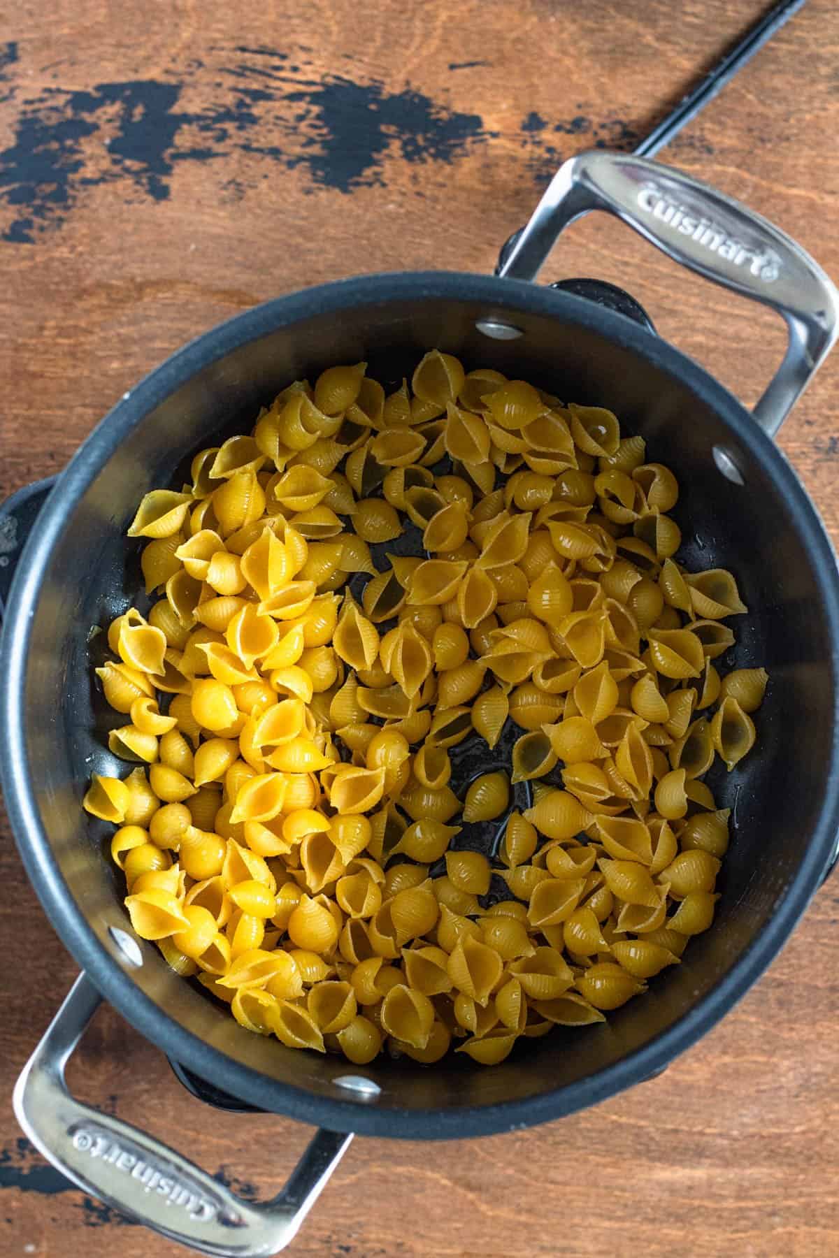 Shell pasta added to a saucepan to make sopa de conchas. 