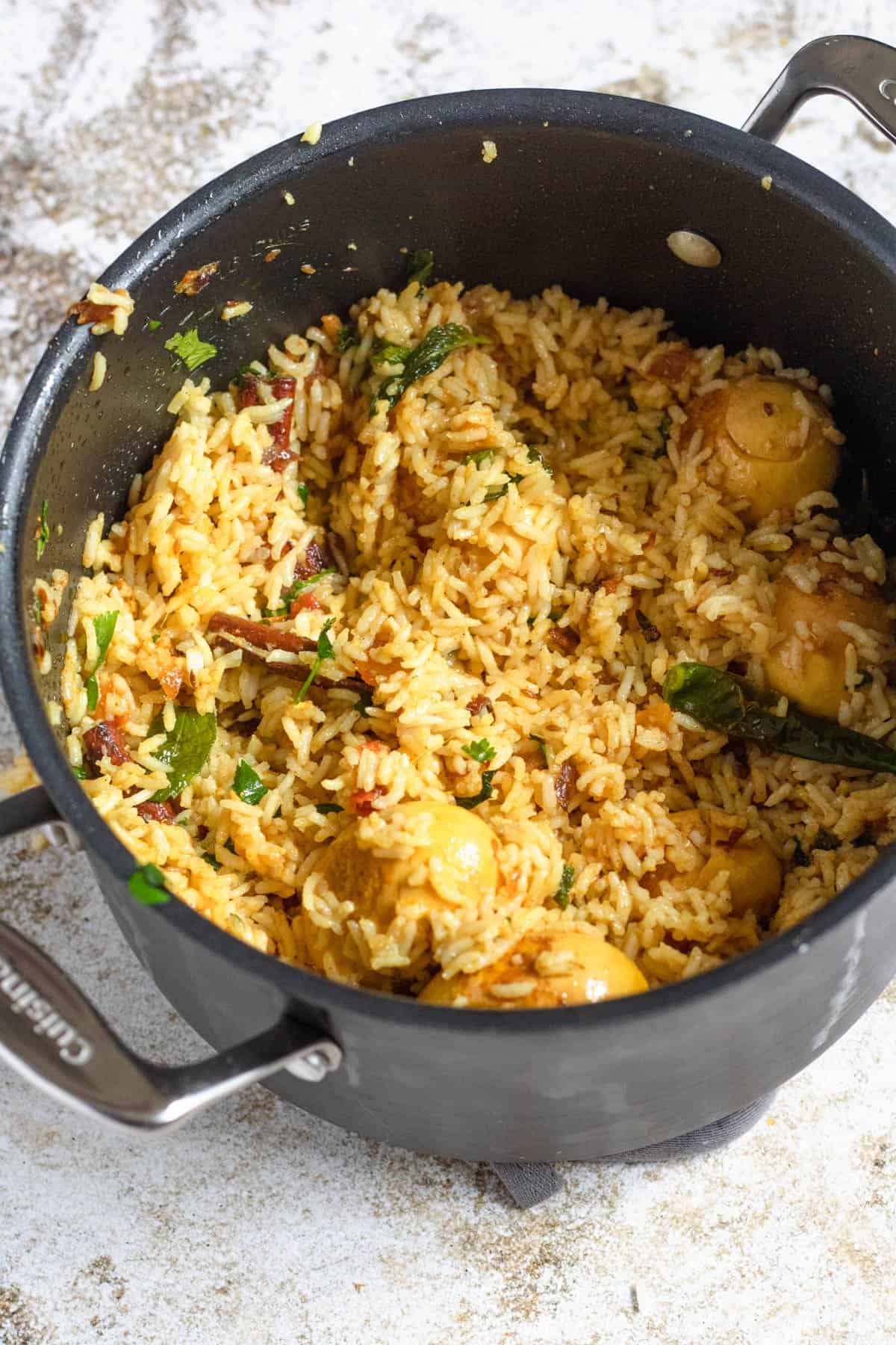 All the seasonings and rice and eggs combined together for the egg biryani  recipe. 