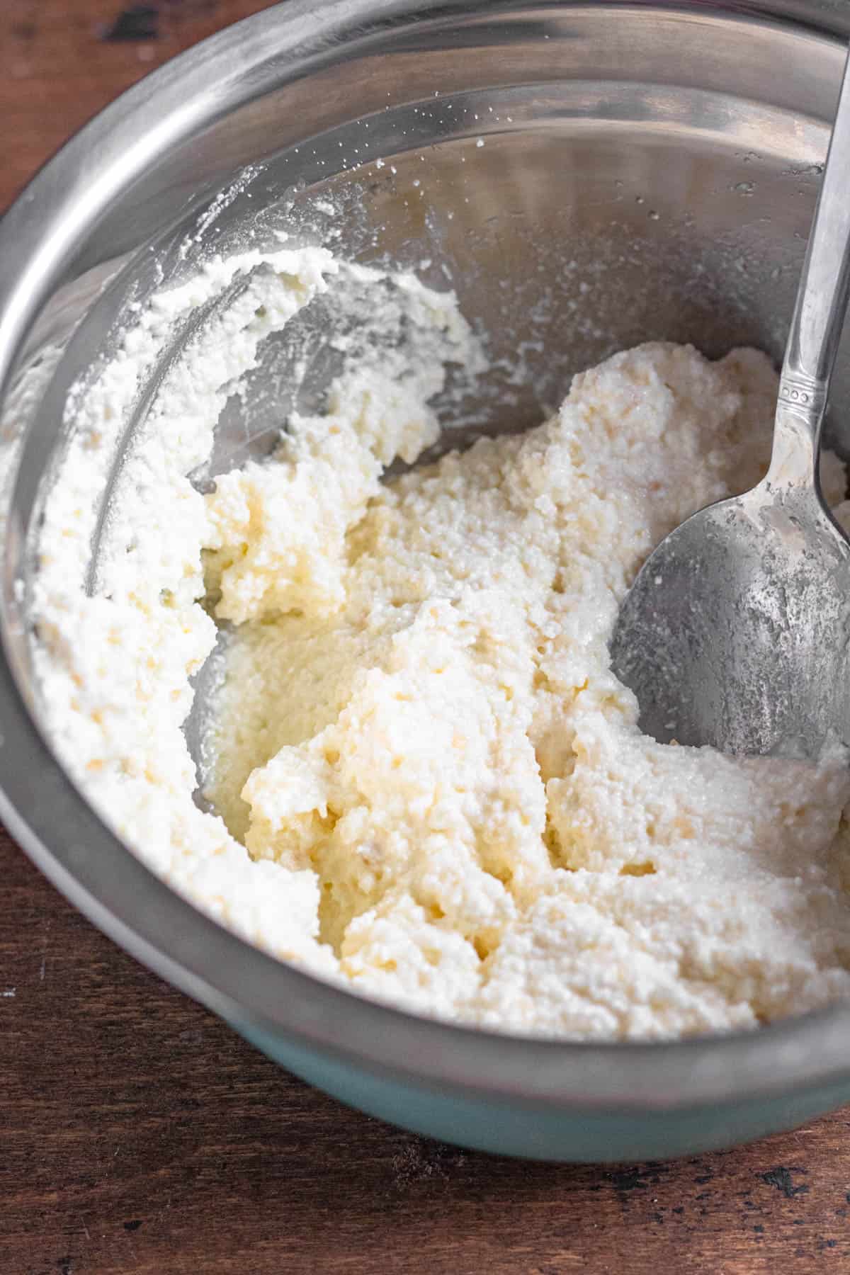 Ricotta mixture being combined in a small mixing bowl. 