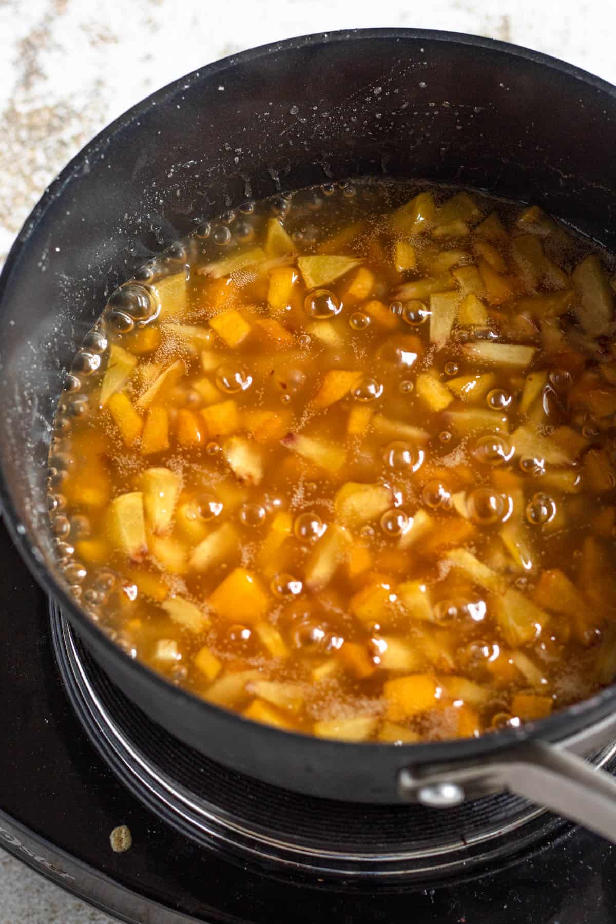 Filling cooking and thickening up for peach cobbler egg rolls. 