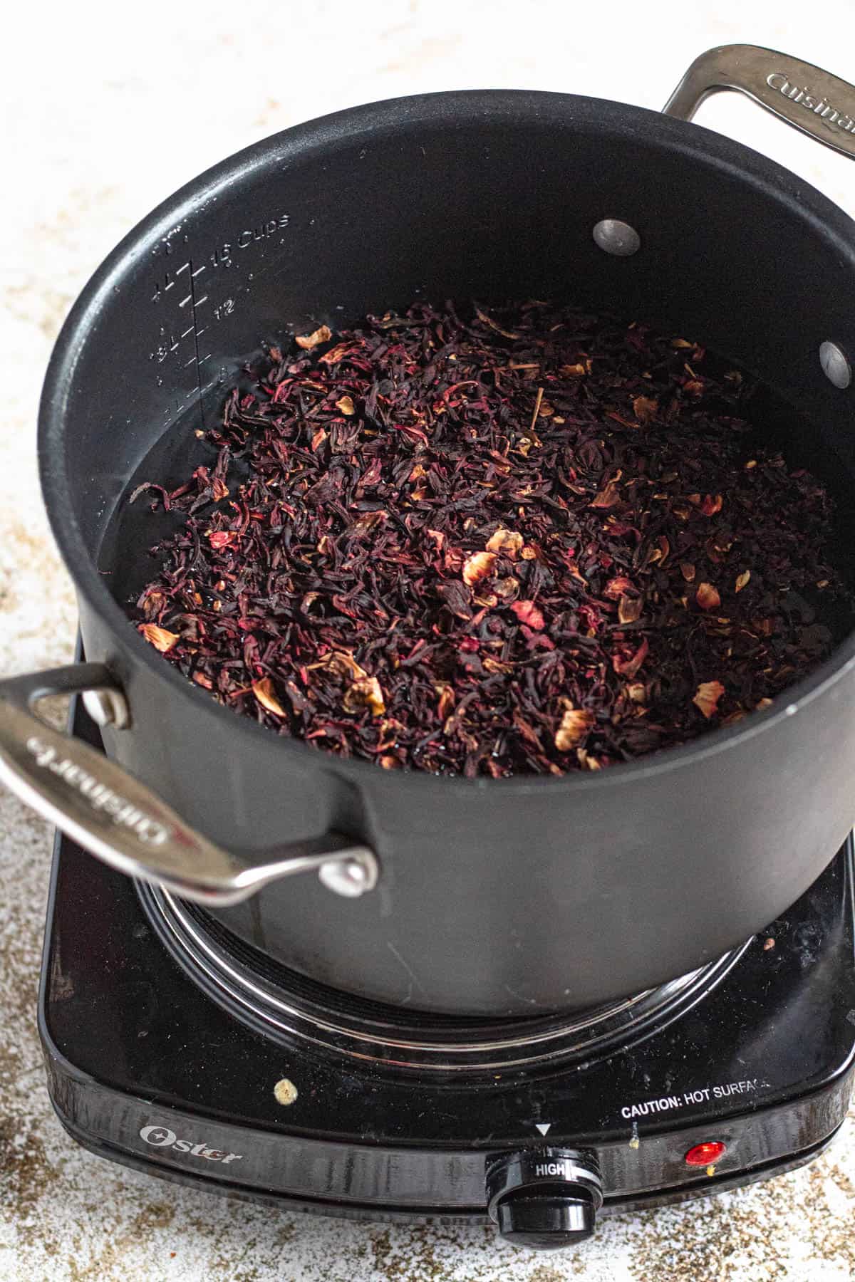 Dried hibiscus flower added to a pot. 