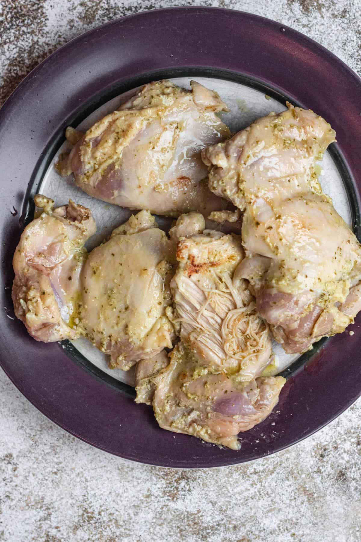 Plate of sauted brown chicken before being cooked in the instant pot fully. 