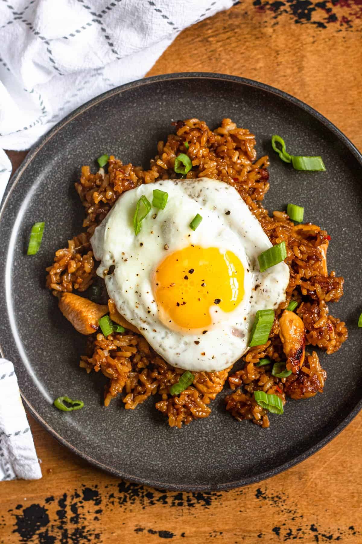 A plate of nasi goreng with a fried egg on top. 