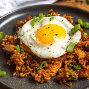 Nasi goreng (fried rice) on a plate and topped with a fried egg.