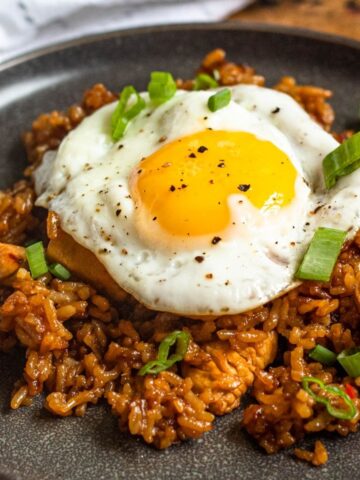 Nasi goreng (fried rice) on a plate and topped with a fried egg.