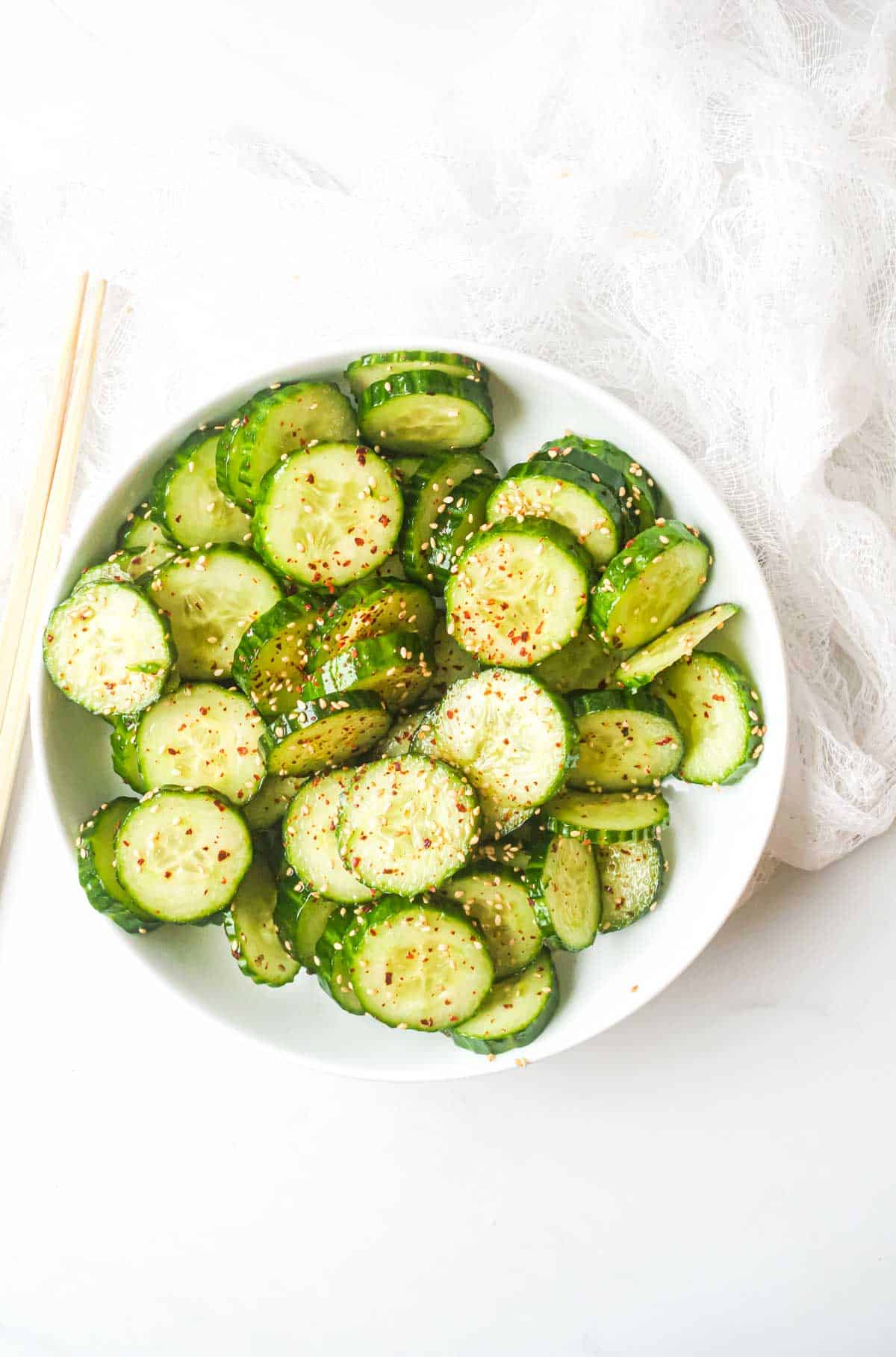 Asian cucumber salad served on a platter with chopsticks. | Recipes From a Pantry