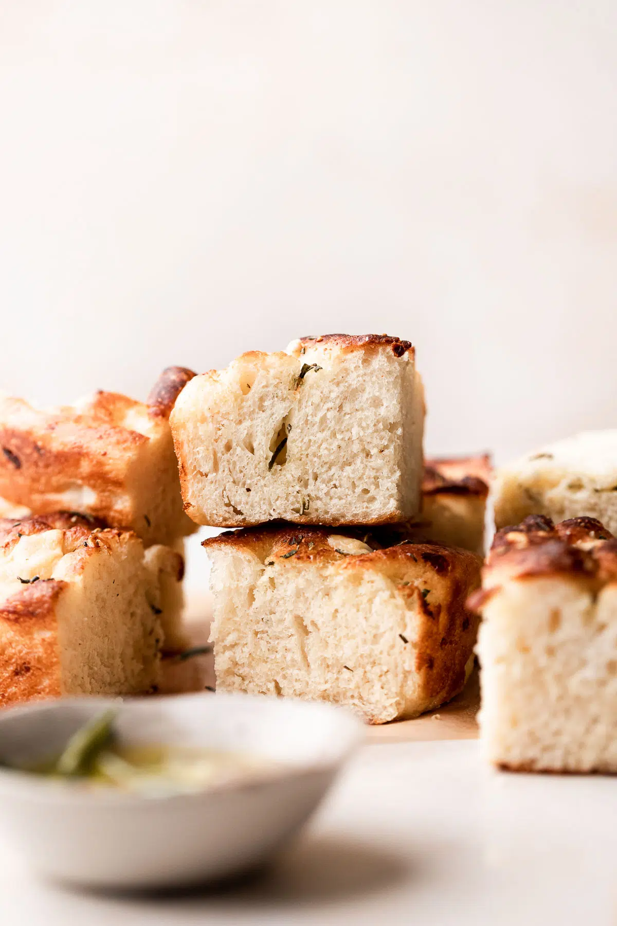 No knead focaccia bread cut into squares and stacked together. 