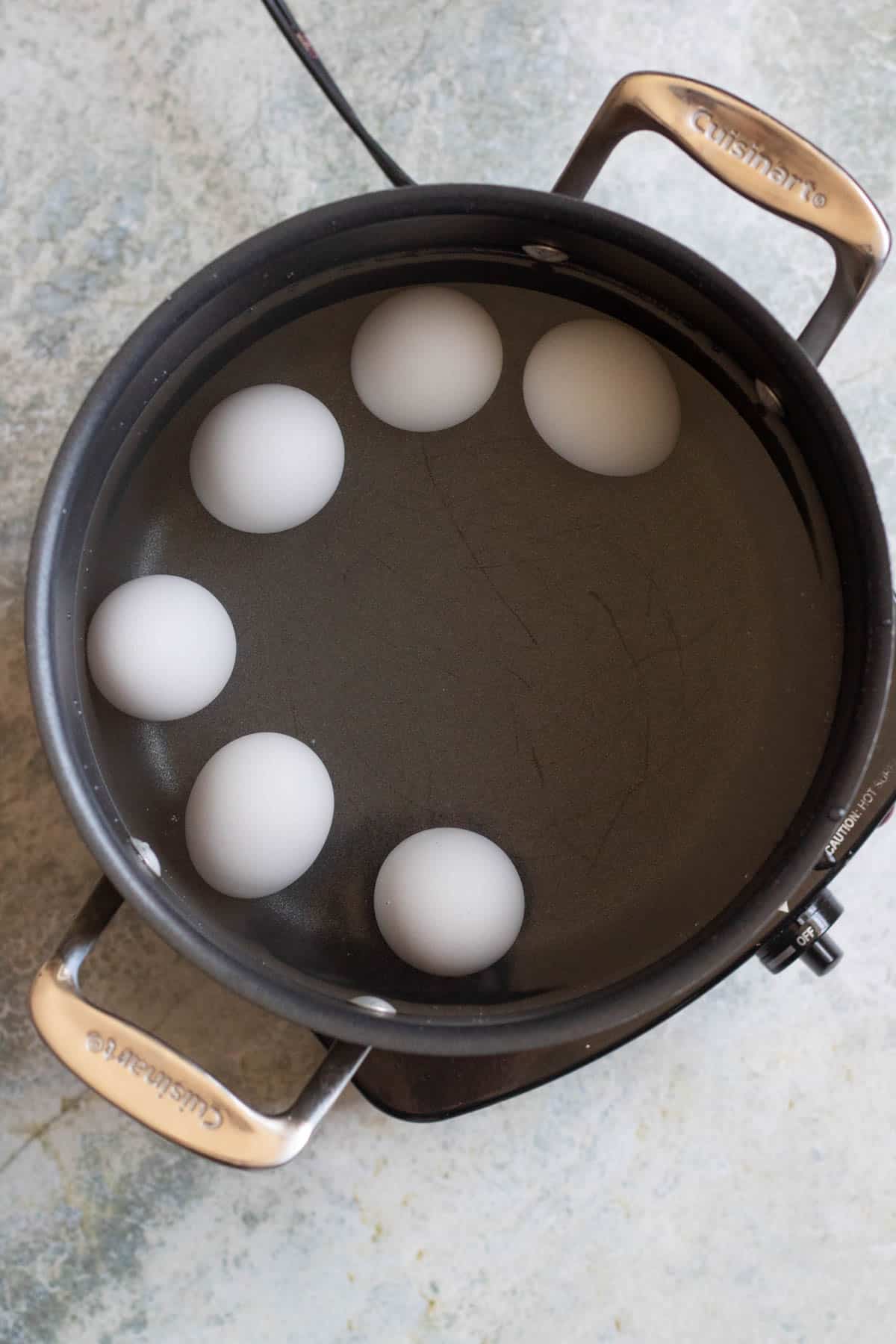 A pot with eggs in water. 