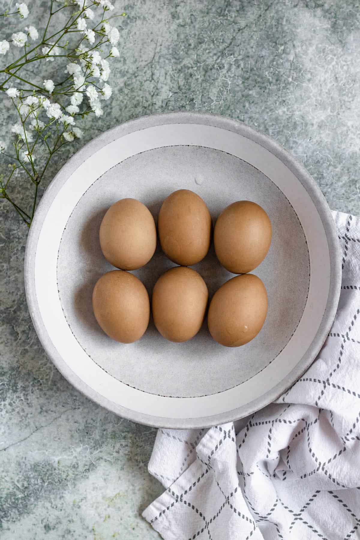 Dyed brown eggs in a shallow bowl. 