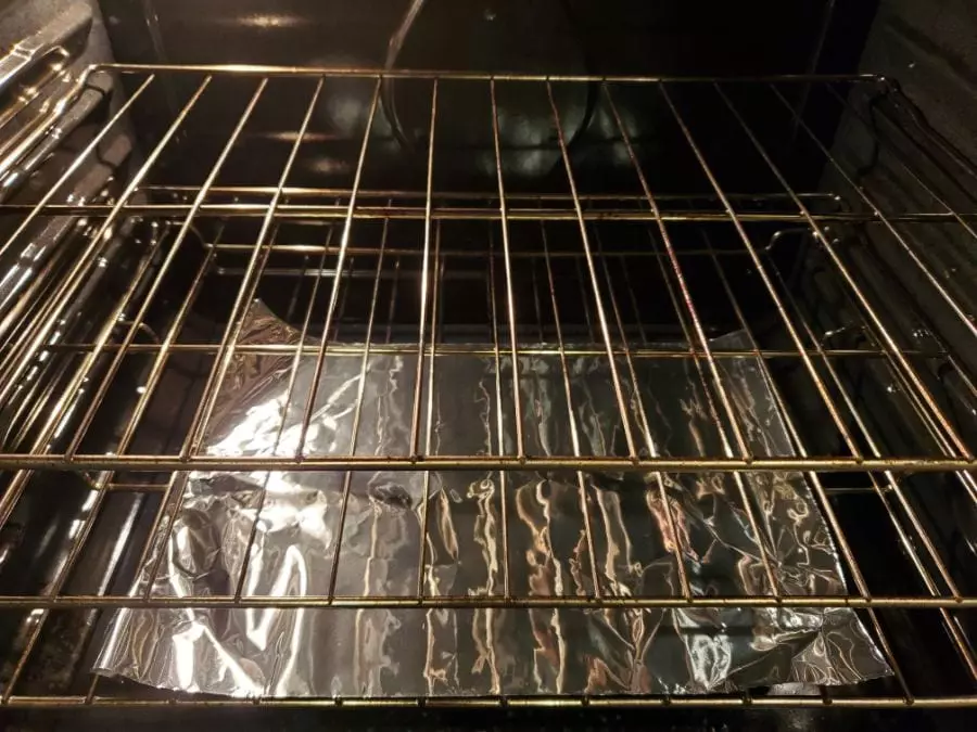 Aluminum foil covering the bottom of an oven. 