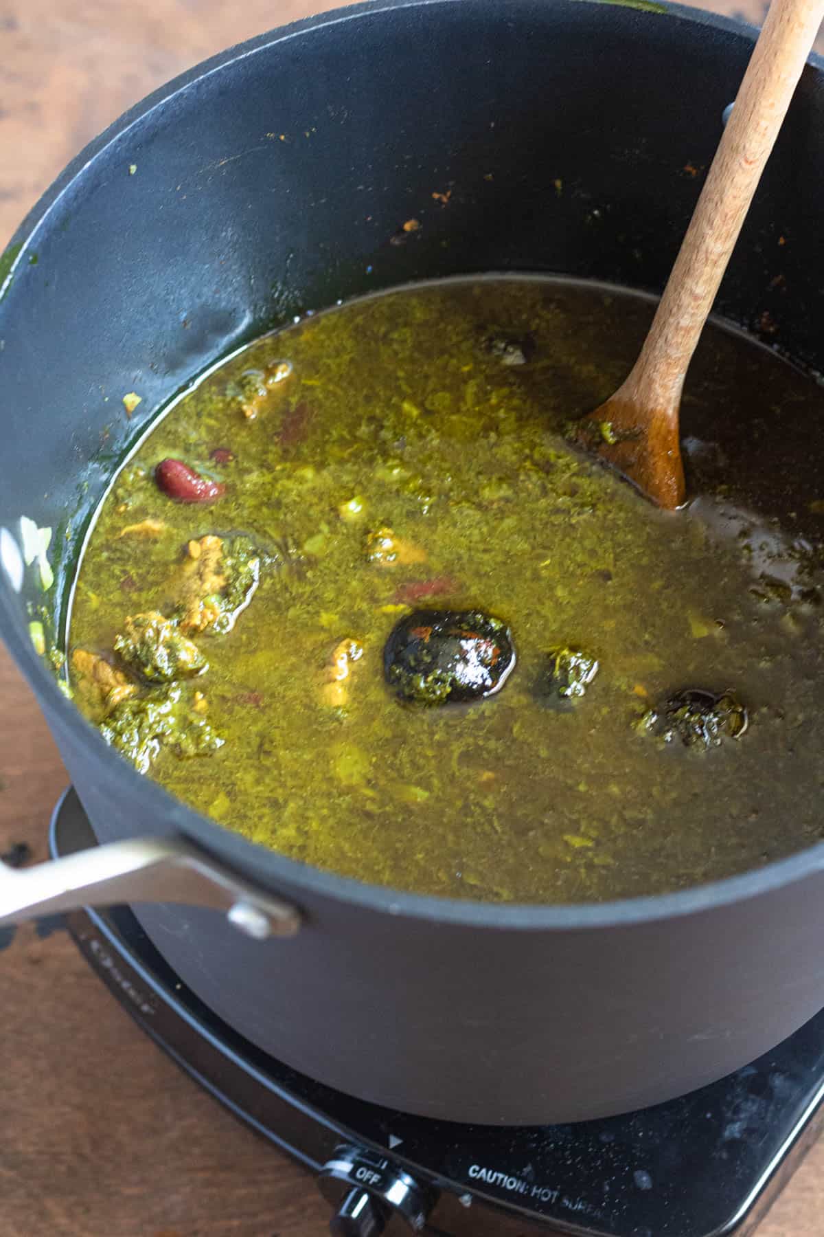 Dried limes added to the ghormeh sabzi before simmering. 