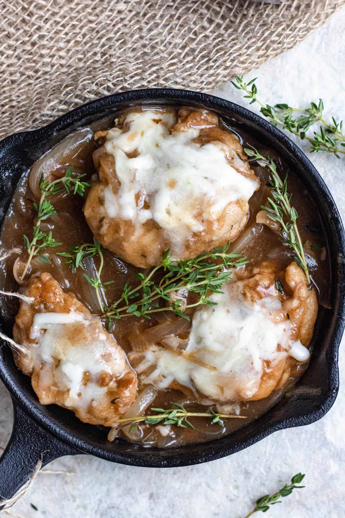 Cast iron pan of french onion chicken. 