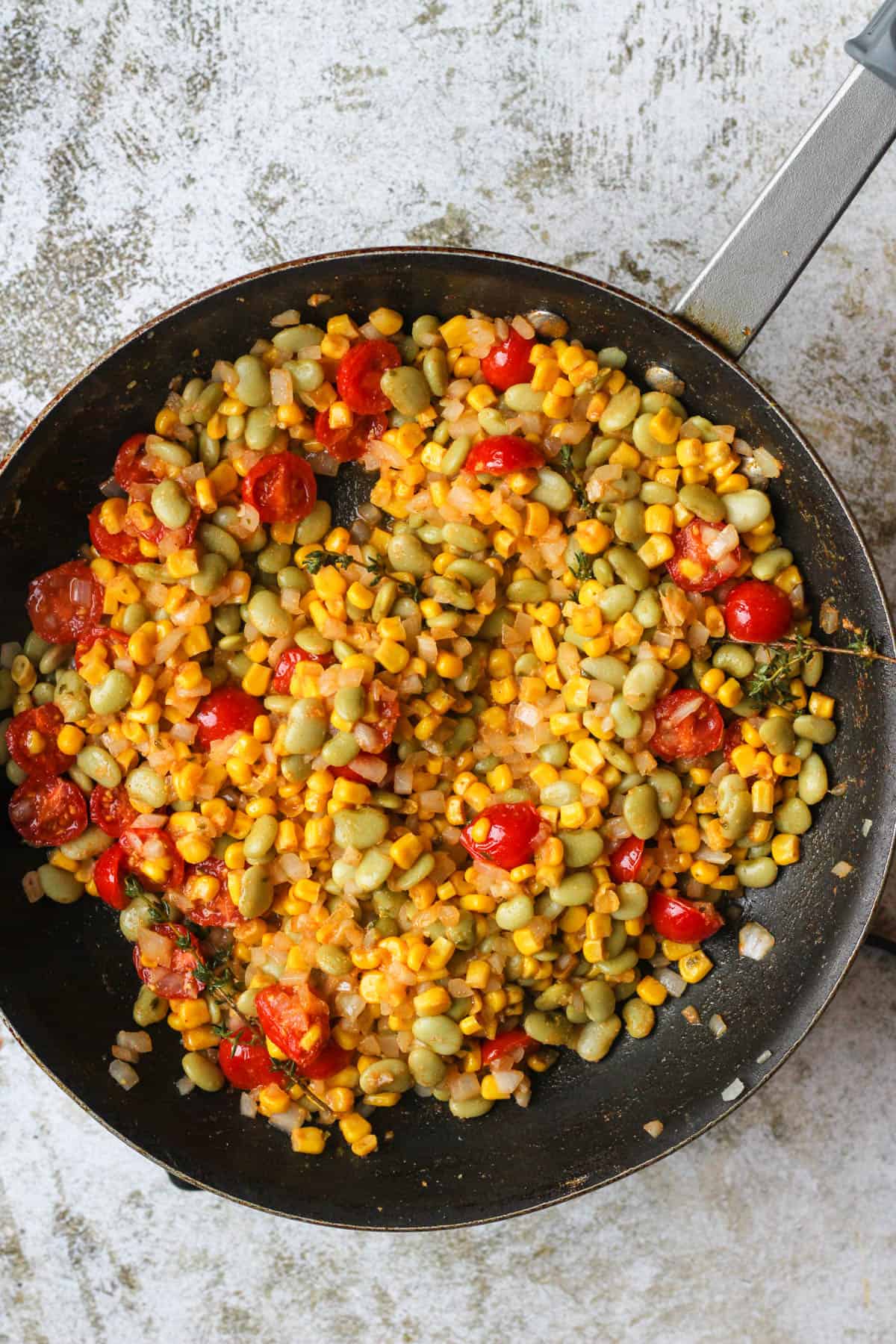 Frying pan with lima beans and succotash ready to serve. 