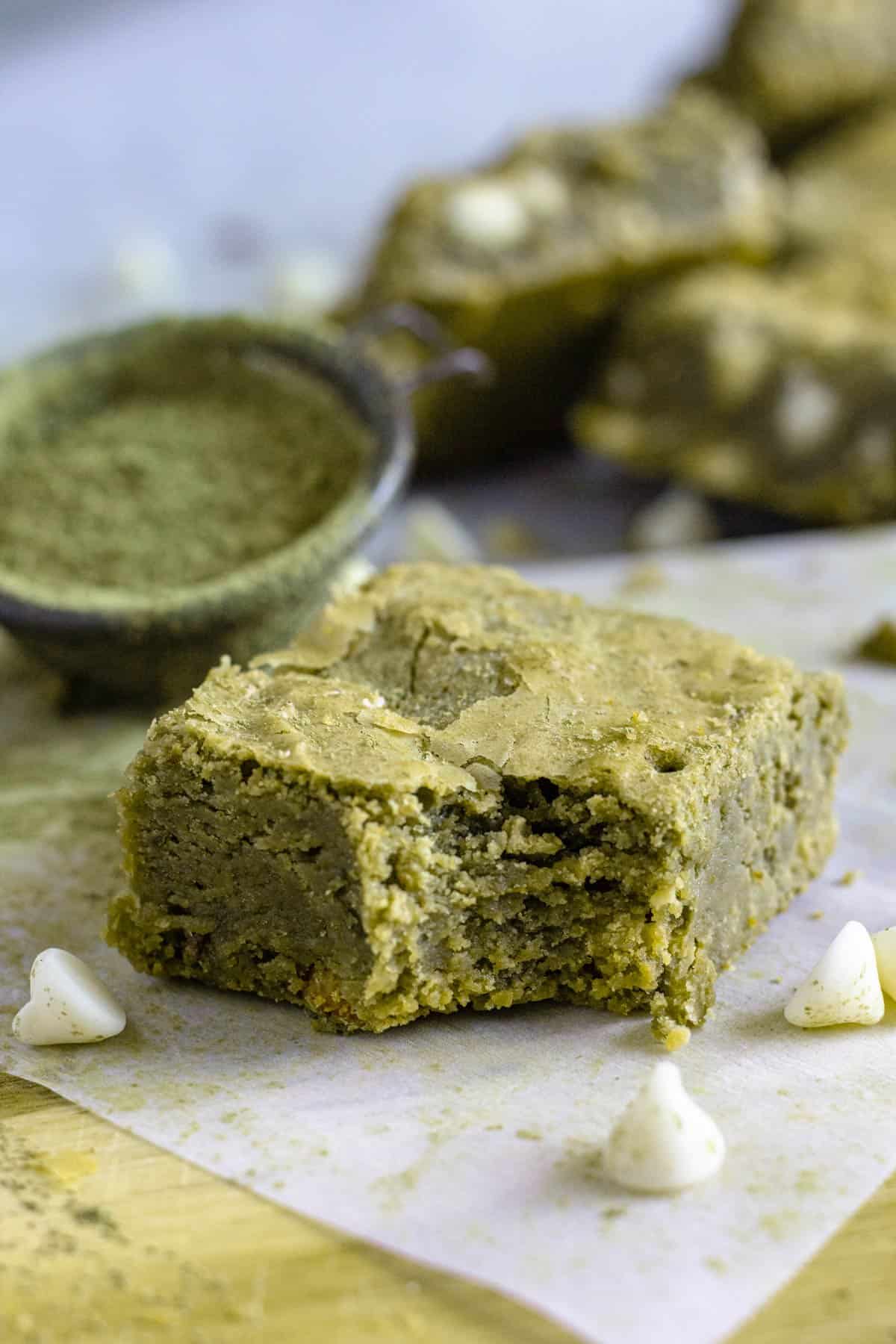 Matcha brownies with a bite taken out of the corner. 
