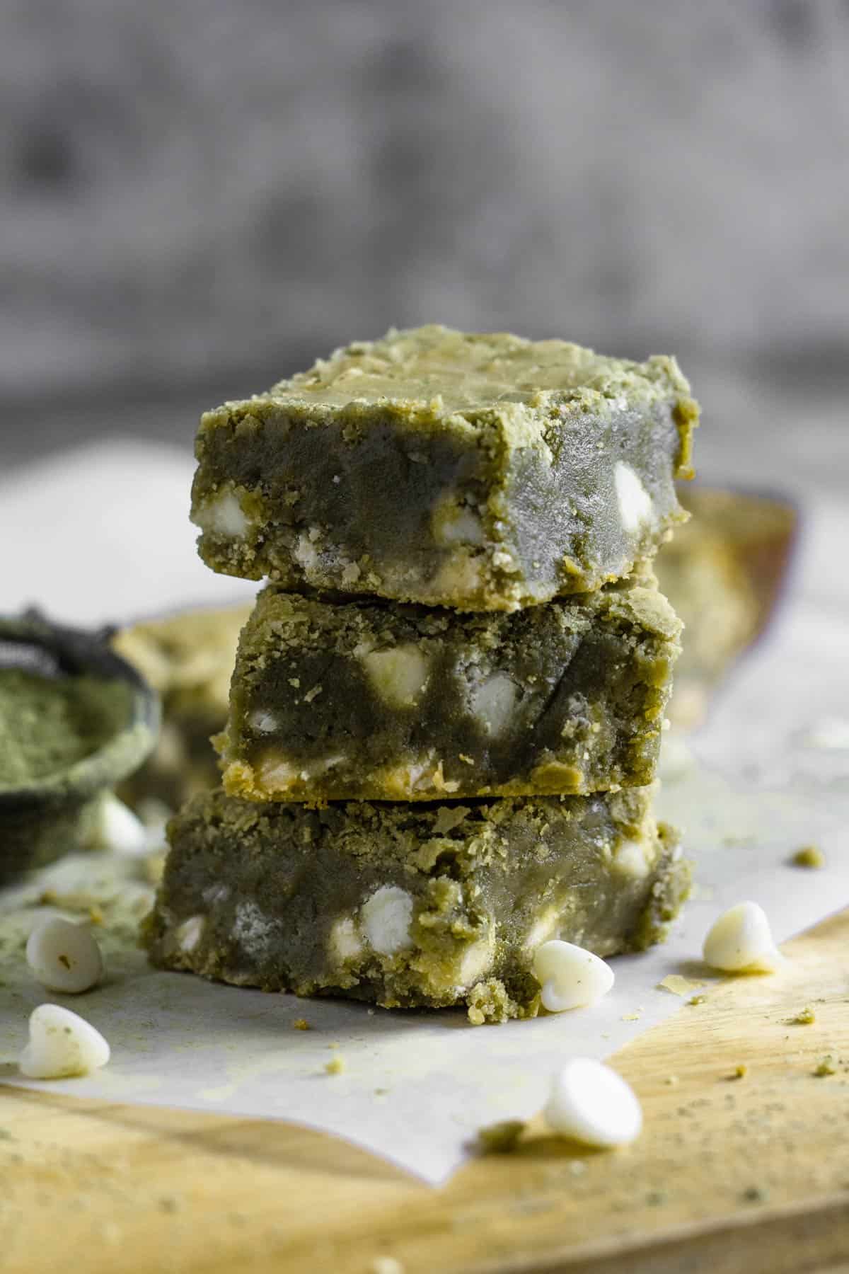 3 square cut matcha brownies on top of one another. 