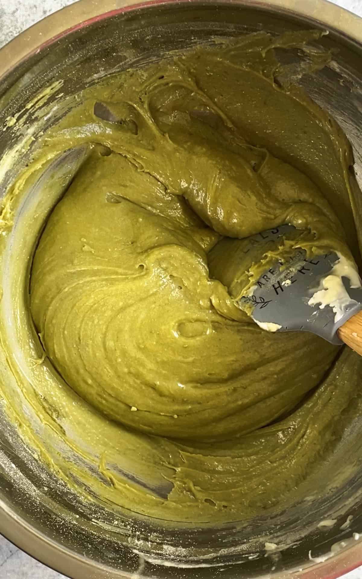 Matcha and other dry ingredients added to the bowl of wet ingredients. 