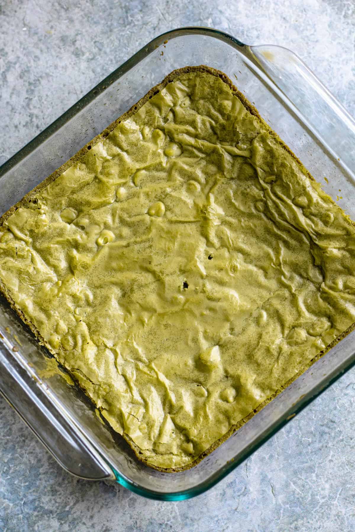 Baked matcha brownies cooling in the pan. 
