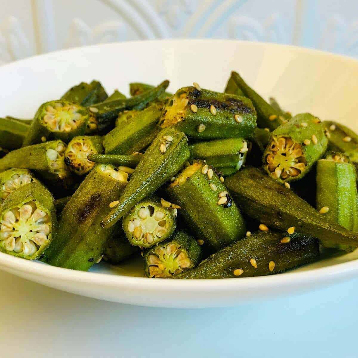 A serving bowl of oven roasted okra. 