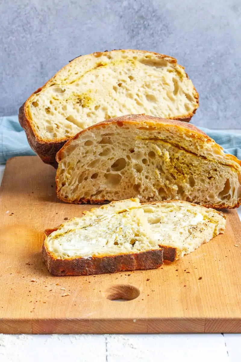 Rosemary Garlic Sourdough Bread slices of bread on a cutting bread. 