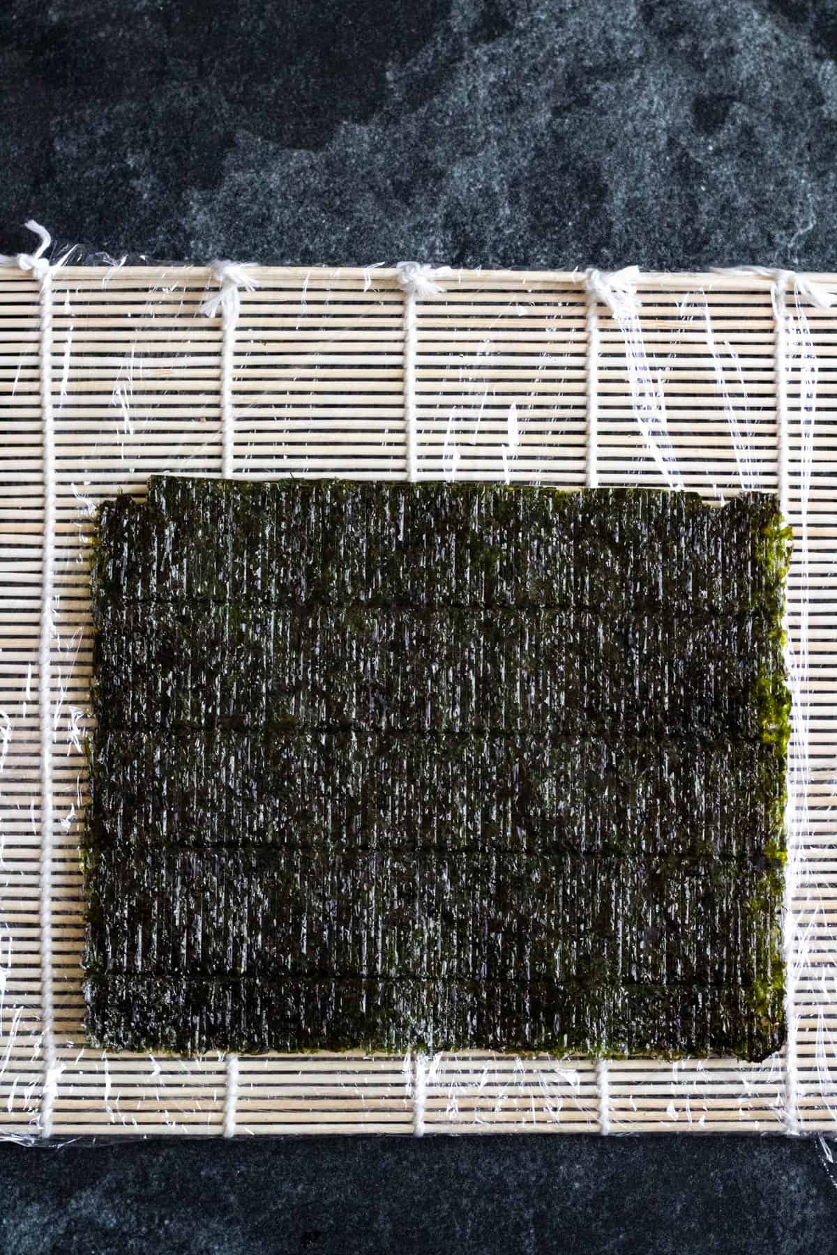 Nori sheet on a sushi mat. 