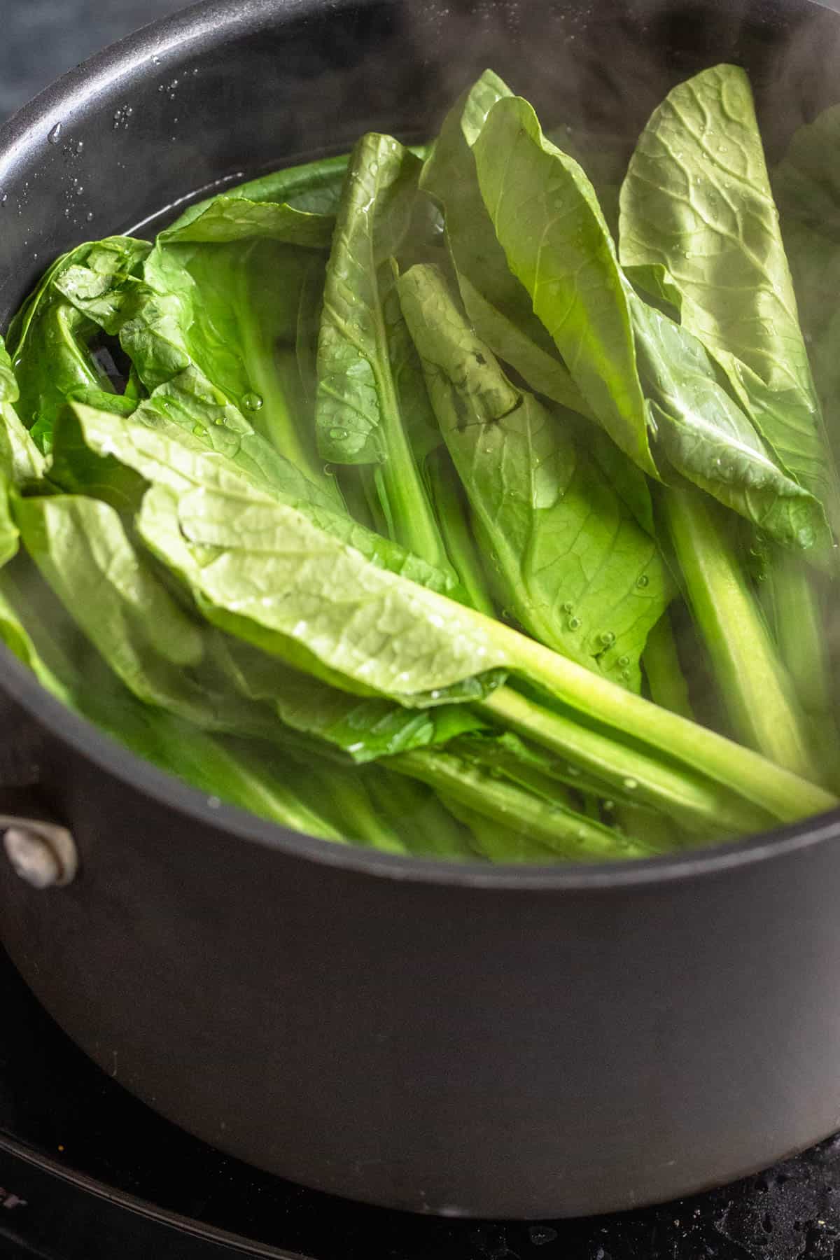 Yu choy in a pot of water. 